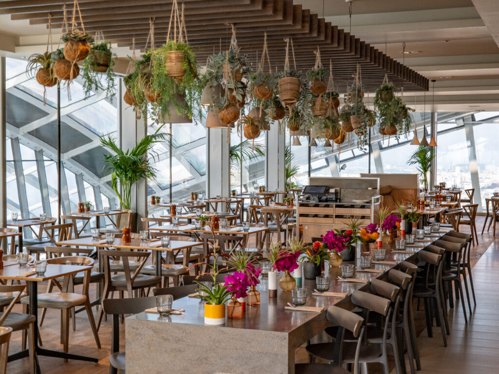 Darwin Brasserie restaurant at Sky Garden London with dining tables and city views